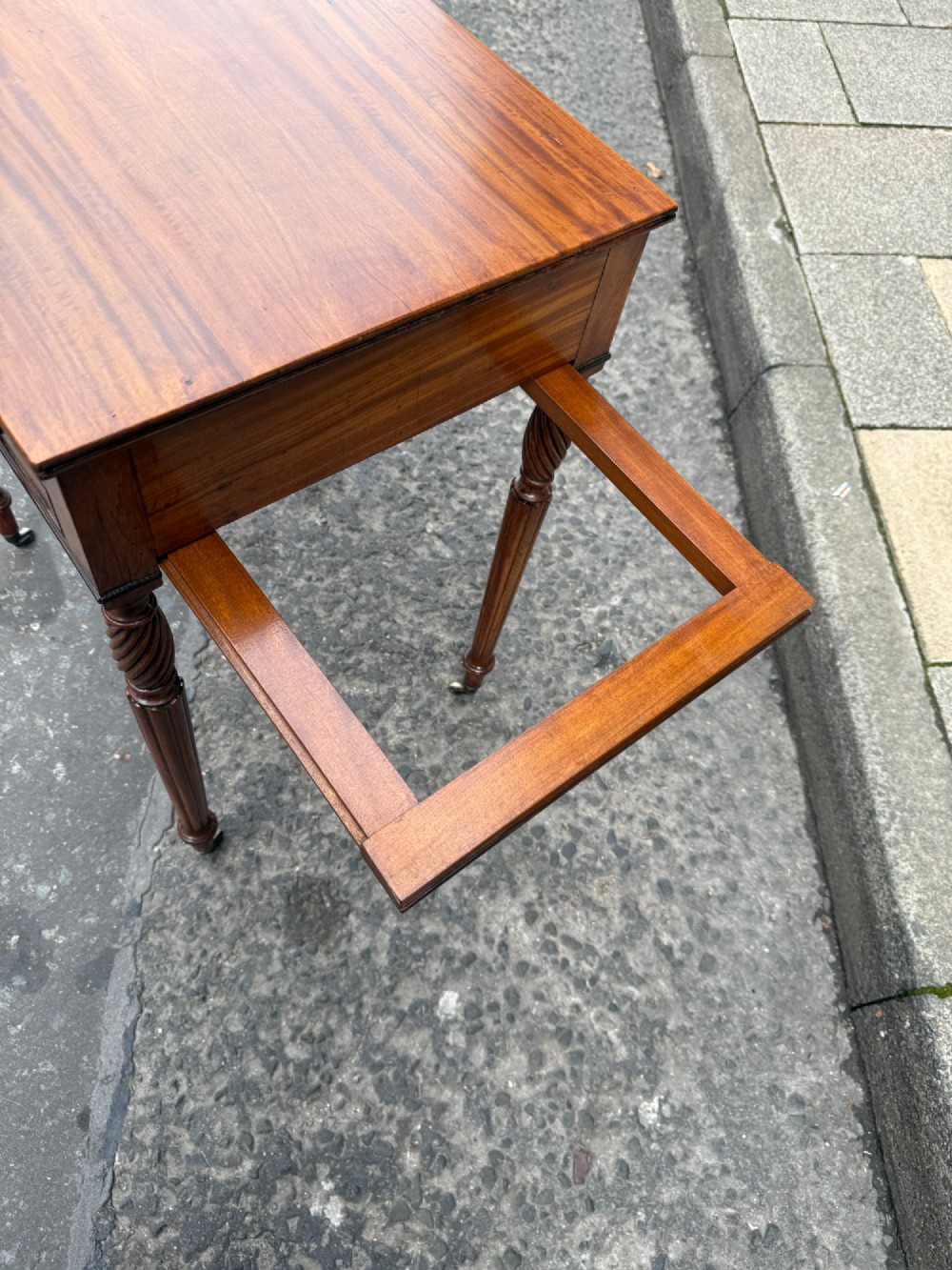 A Scottish Regency satinwood ladies work table featuring a rectangular top, two drawers with round knobs, spiral turned legs, and brass castors. View IV