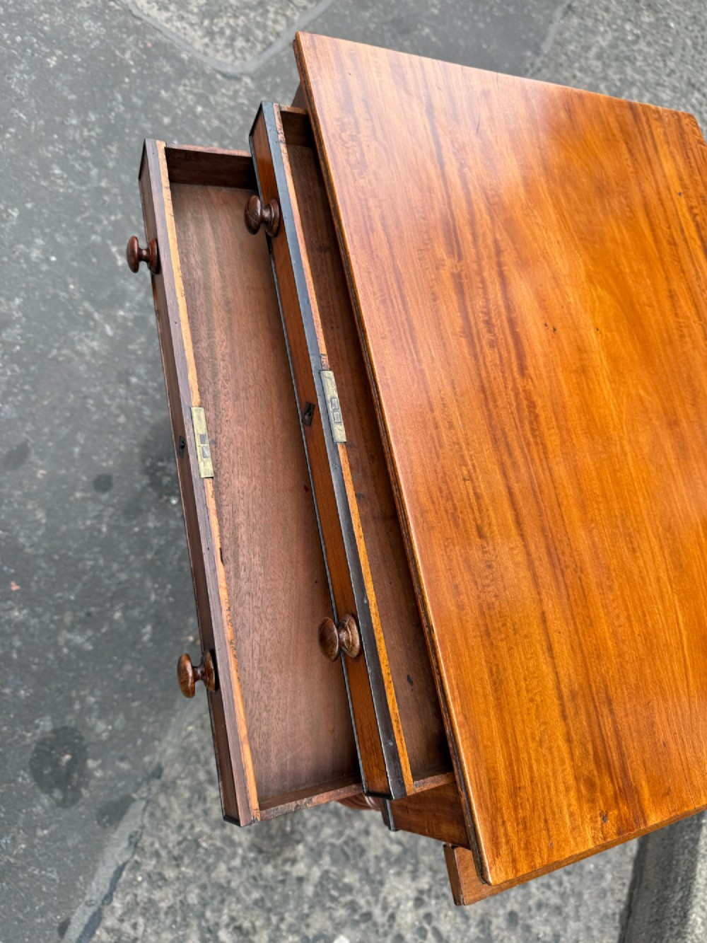 A Scottish Regency satinwood ladies work table featuring a rectangular top, two drawers with round knobs, spiral turned legs, and brass castors. View V