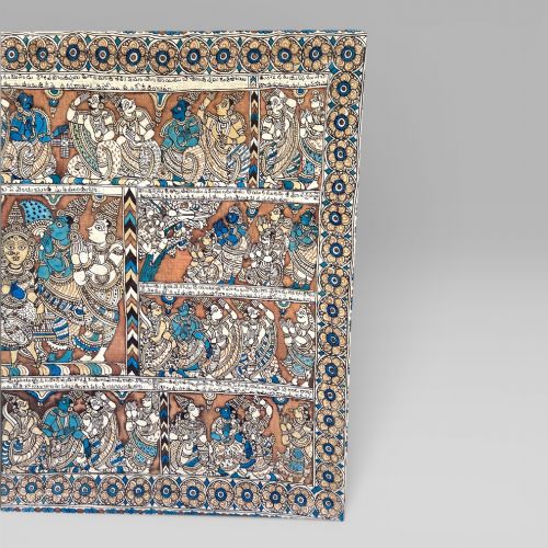 fig 2. A rectangular Indian Kalamkari cotton textile displaying narrative panels filled with hand-drawn Hindu deities framed by a decorative floral border in blue, beige, and terracotta tones.