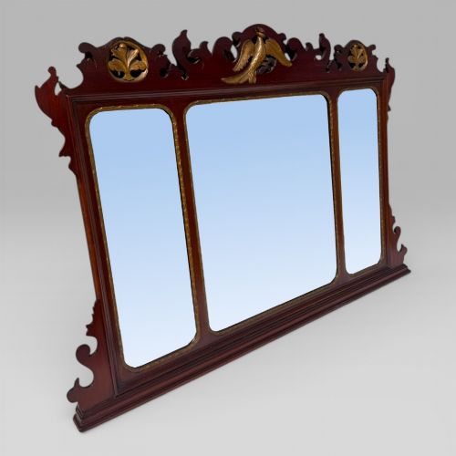 fig 1. A 19th-century Chippendale style mahogany wall mirror featuring three glass panels, gilt trim, carved shell medallions, and a central gilded bird cresting.