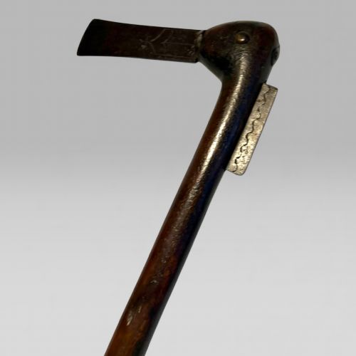 fig 1. A 19th-century Dahomey messenger recade axe featuring an angled hardwood shaft and a flat iron blade.