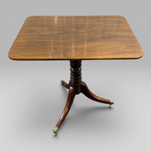 ANTIQUE REGENCY MAHOGANY TILT TOP OCCASIONAL TABLE WITH BRASS CASTERS
