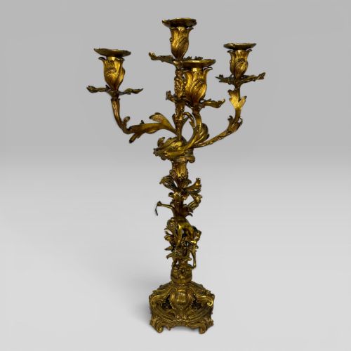 fig 1. A pair of late nineteenth-century French Rococo gilt bronze candelabra with figural stems, scrolling floral arms, and ornate bases.