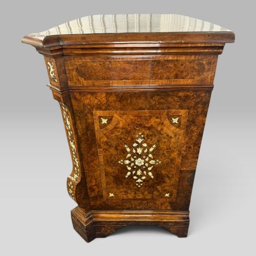 fig 5. An Italian Baroque walnut commode featuring floral bone inlays across six drawer fronts, side panels, and top surface, supported by bracket feet.