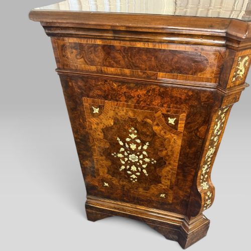 fig 6. An Italian Baroque walnut commode featuring floral bone inlays across six drawer fronts, side panels, and top surface, supported by bracket feet.