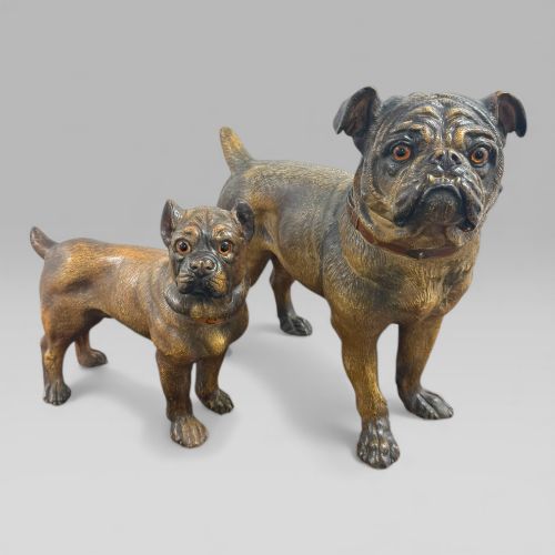 fig 1. A dark brown painted terracotta dog sculpture standing upright with glass eyes and a moulded collar.