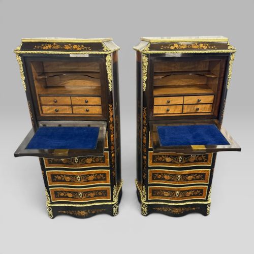 fig 2. A pair of French Napoleon III narrow serpentine chests in kingwood and tulipwood featuring floral marquetry, gilt-bronze mounts, and marble tops.