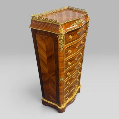 fig 3. A tall antique French kingwood and rosewood secretaire chest featuring parquetry veneers, ornate gilt bronze mounts, seven drawer fronts, and a pierced brass gallery top.
