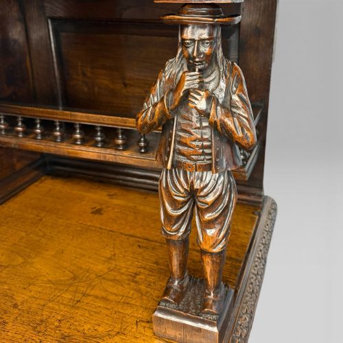 fig 5. A mid-nineteenth-century dark oak French Breton buffet cabinet with detailed folk carvings, relief panels, ship wheel motifs, and carved human figure supports.