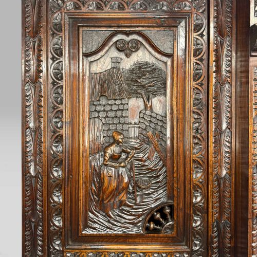 fig 8. A mid-nineteenth-century dark oak French Breton buffet cabinet with detailed folk carvings, relief panels, ship wheel motifs, and carved human figure supports.