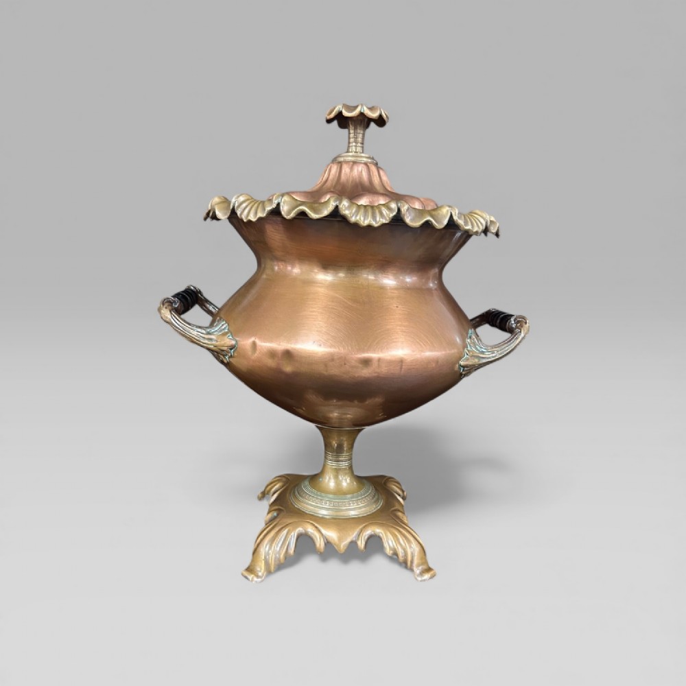 An antique Victorian copper samovar featuring a fluted lid, scalloped brass rim, cast brass side handles, a brass spigot, and a four-footed scroll base. View III