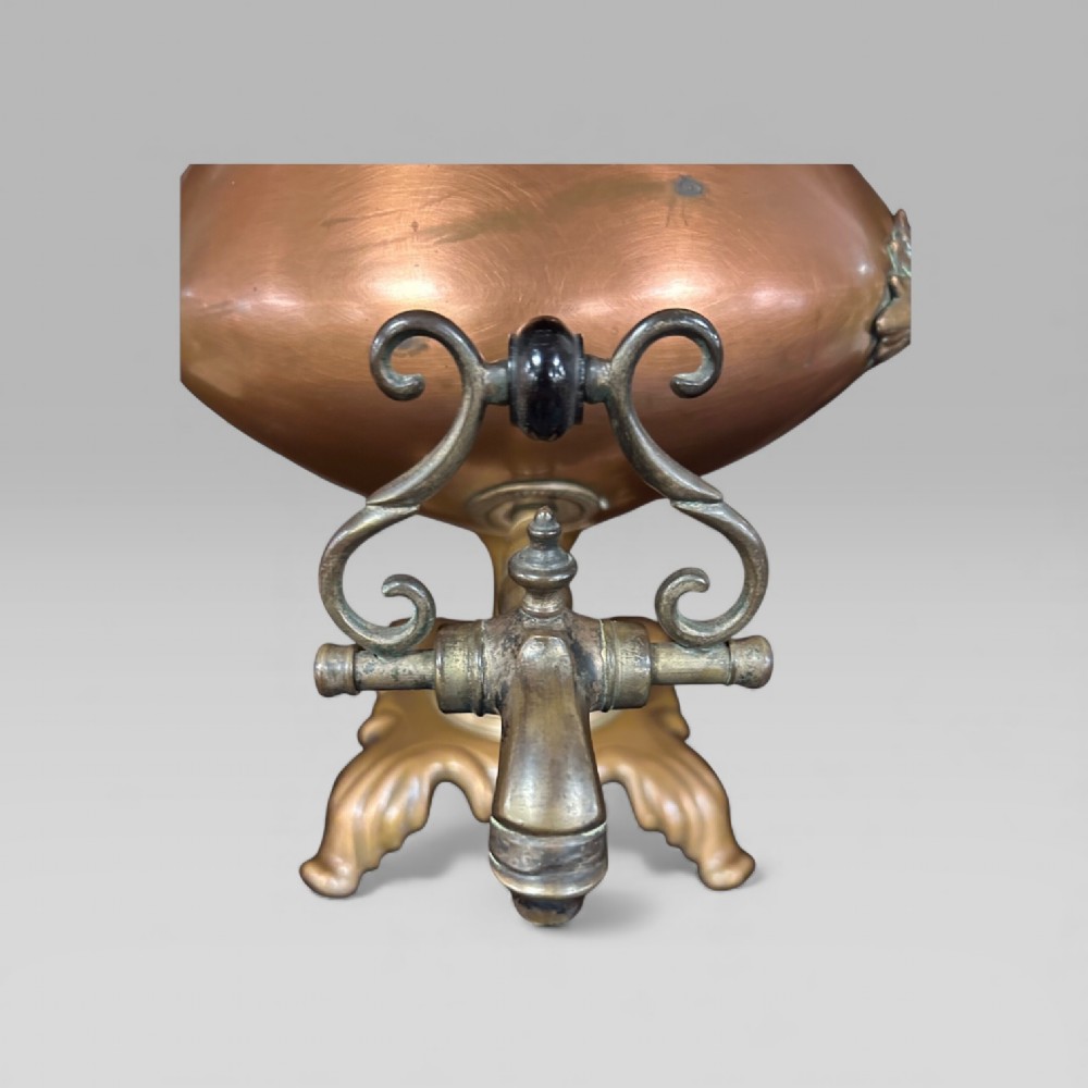 An antique Victorian copper samovar featuring a fluted lid, scalloped brass rim, cast brass side handles, a brass spigot, and a four-footed scroll base. View VII
