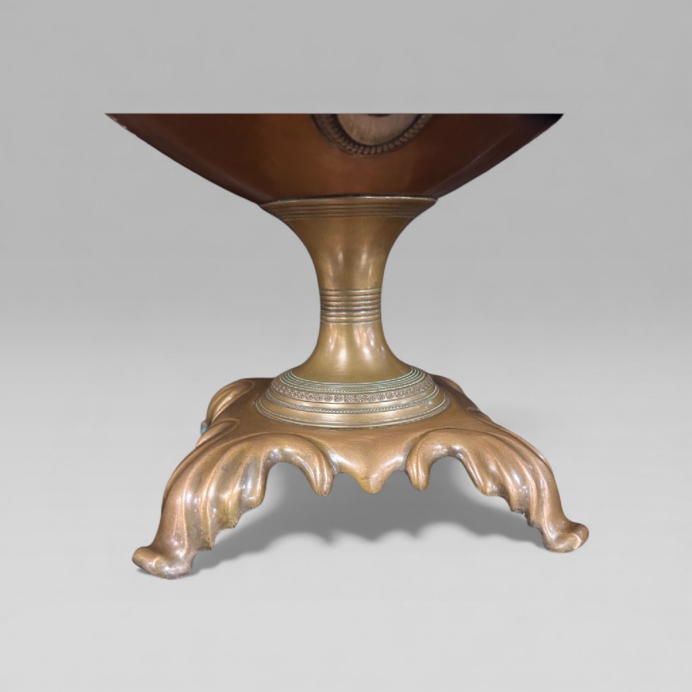 An antique Victorian copper samovar featuring a fluted lid, scalloped brass rim, cast brass side handles, a brass spigot, and a four-footed scroll base. View VIII