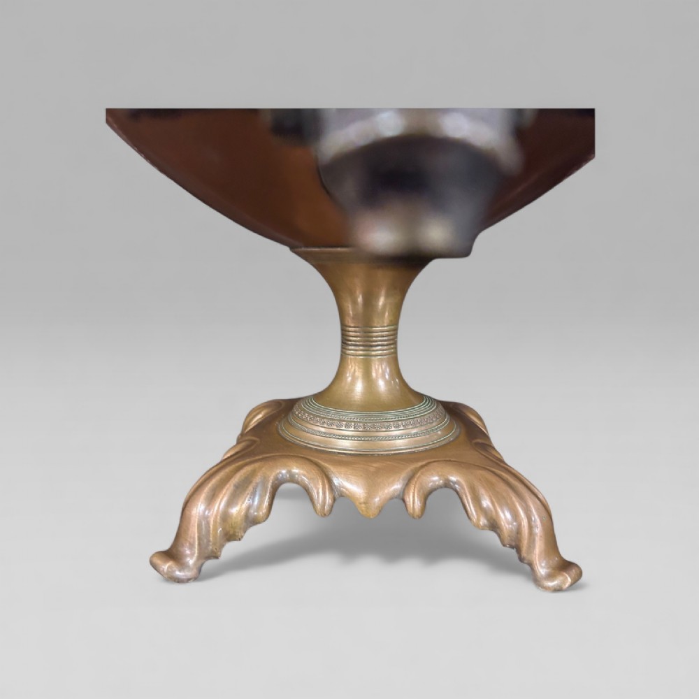 An antique Victorian copper samovar featuring a fluted lid, scalloped brass rim, cast brass side handles, a brass spigot, and a four-footed scroll base. View IX
