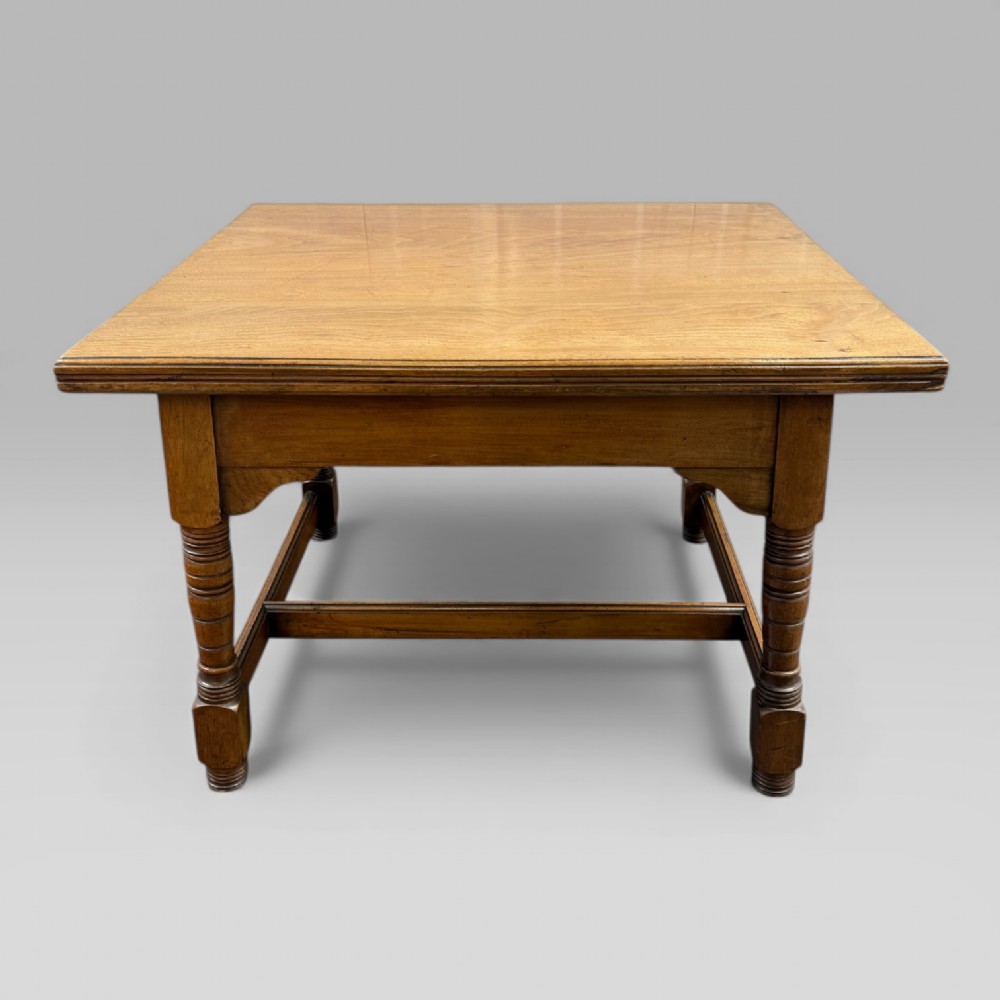 An antique walnut coffee table featuring turned legs, a rectangular top, brass drop handles, and an H-stretcher base. View IX
