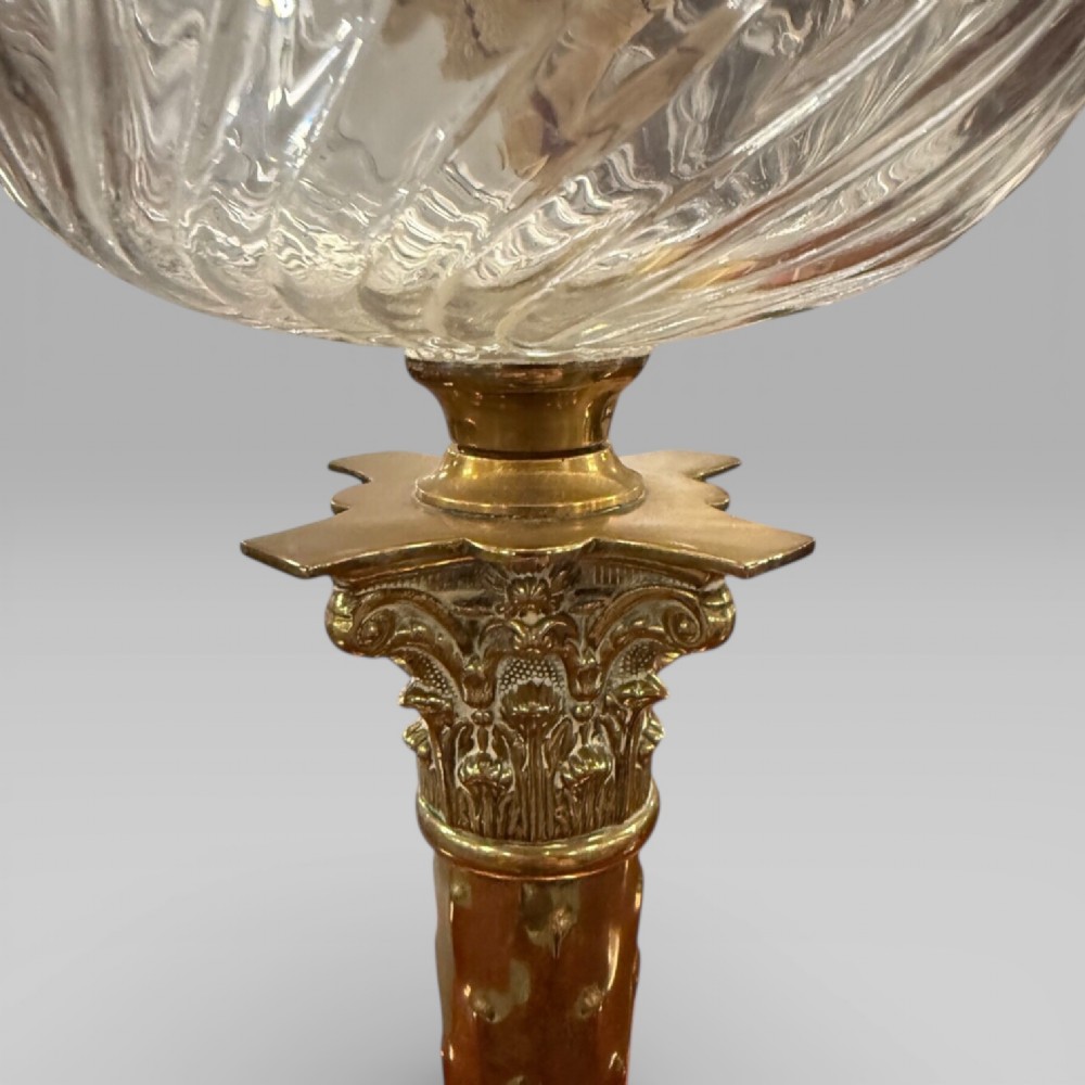 An antique Victorian oil lamp featuring a Corinthian style brass column base, clear glass reservoir, and an etched glass tulip shade with a frilled top rim. View XI
