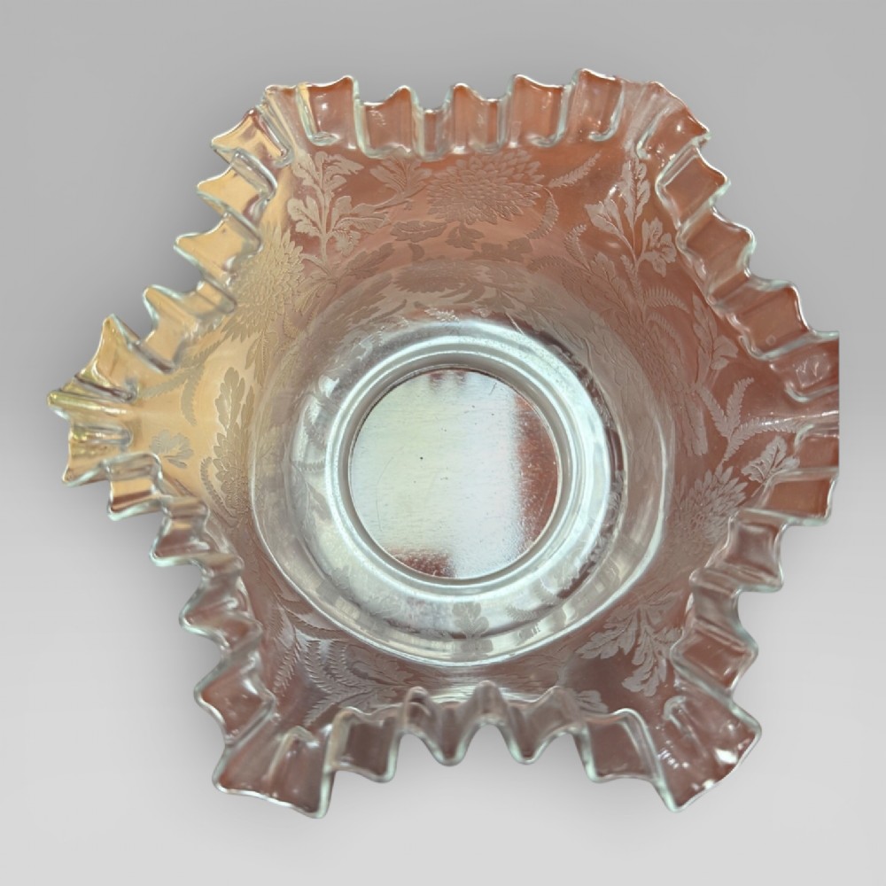 An antique Victorian oil lamp featuring a Corinthian style brass column base, clear glass reservoir, and an etched glass tulip shade with a frilled top rim. View XIV