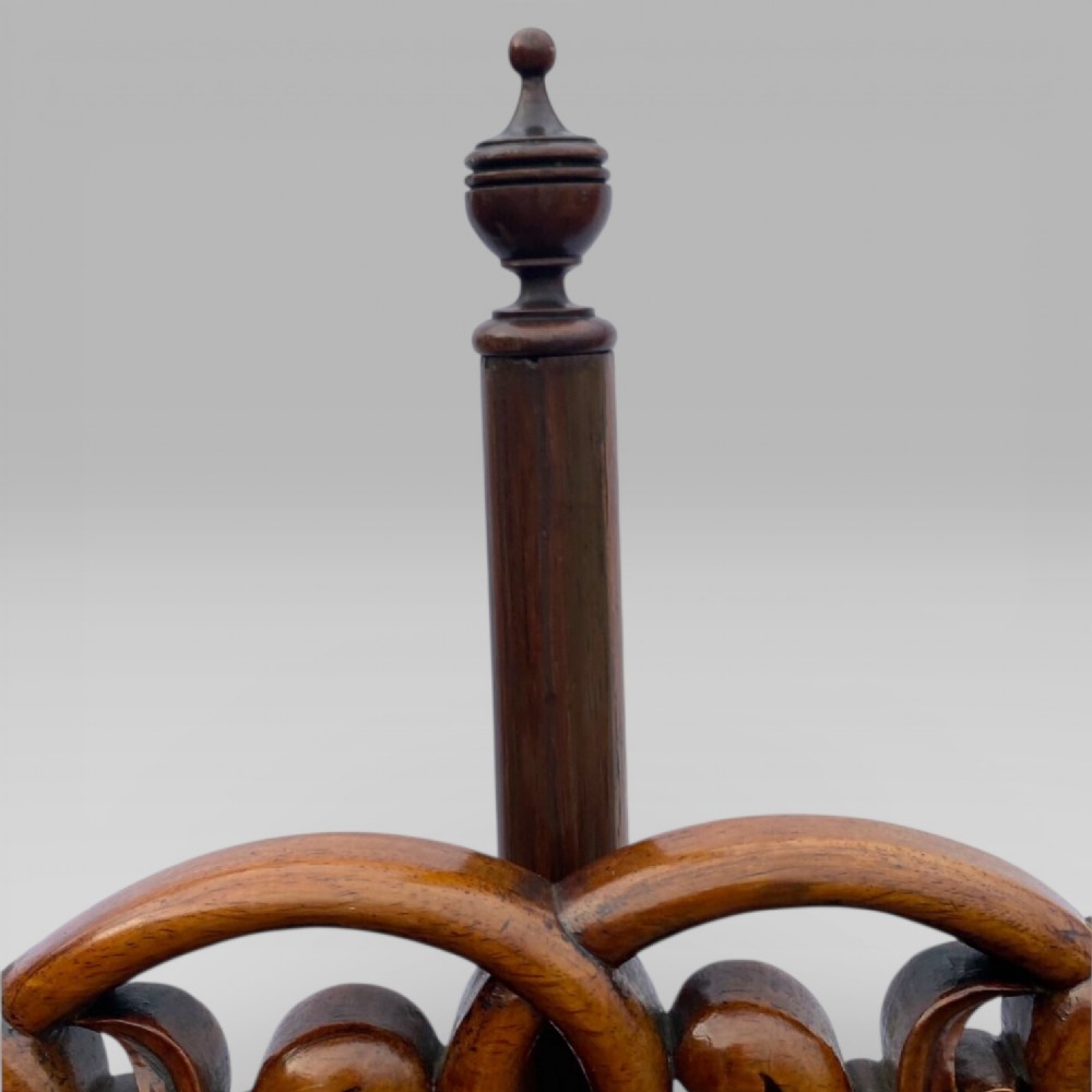 An antique Victorian rosewood pole screen featuring a carved floral tapestry panel mounted on an adjustable central column with a carved tripod base. View VI