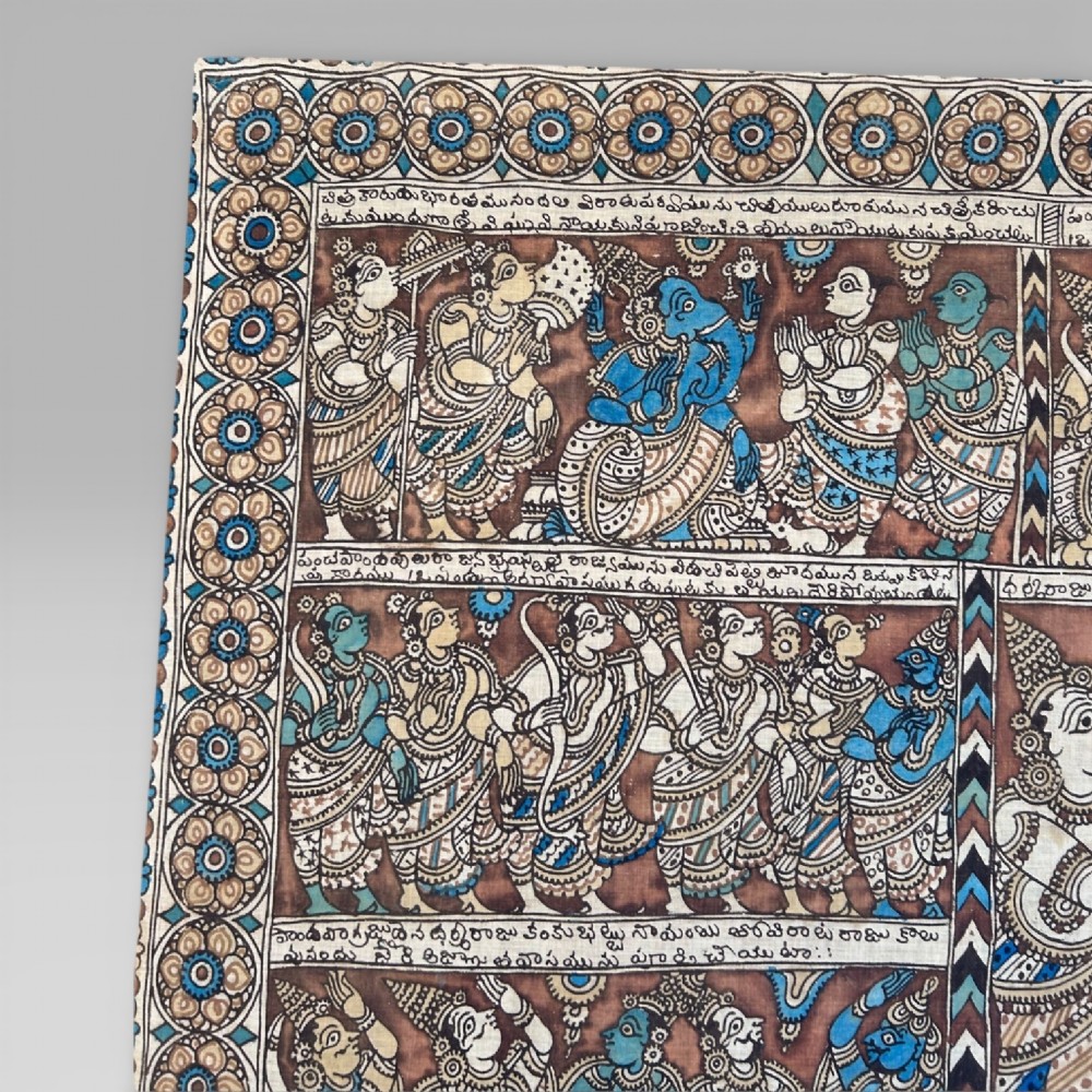 A rectangular Indian Kalamkari cotton textile displaying narrative panels filled with hand-drawn Hindu deities framed by a decorative floral border in blue, beige, and terracotta tones. View IV