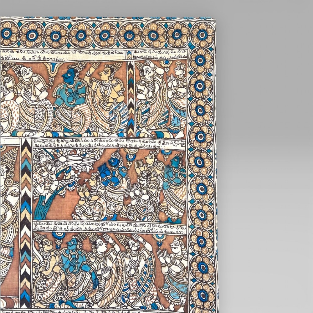 A rectangular Indian Kalamkari cotton textile displaying narrative panels filled with hand-drawn Hindu deities framed by a decorative floral border in blue, beige, and terracotta tones. View VI