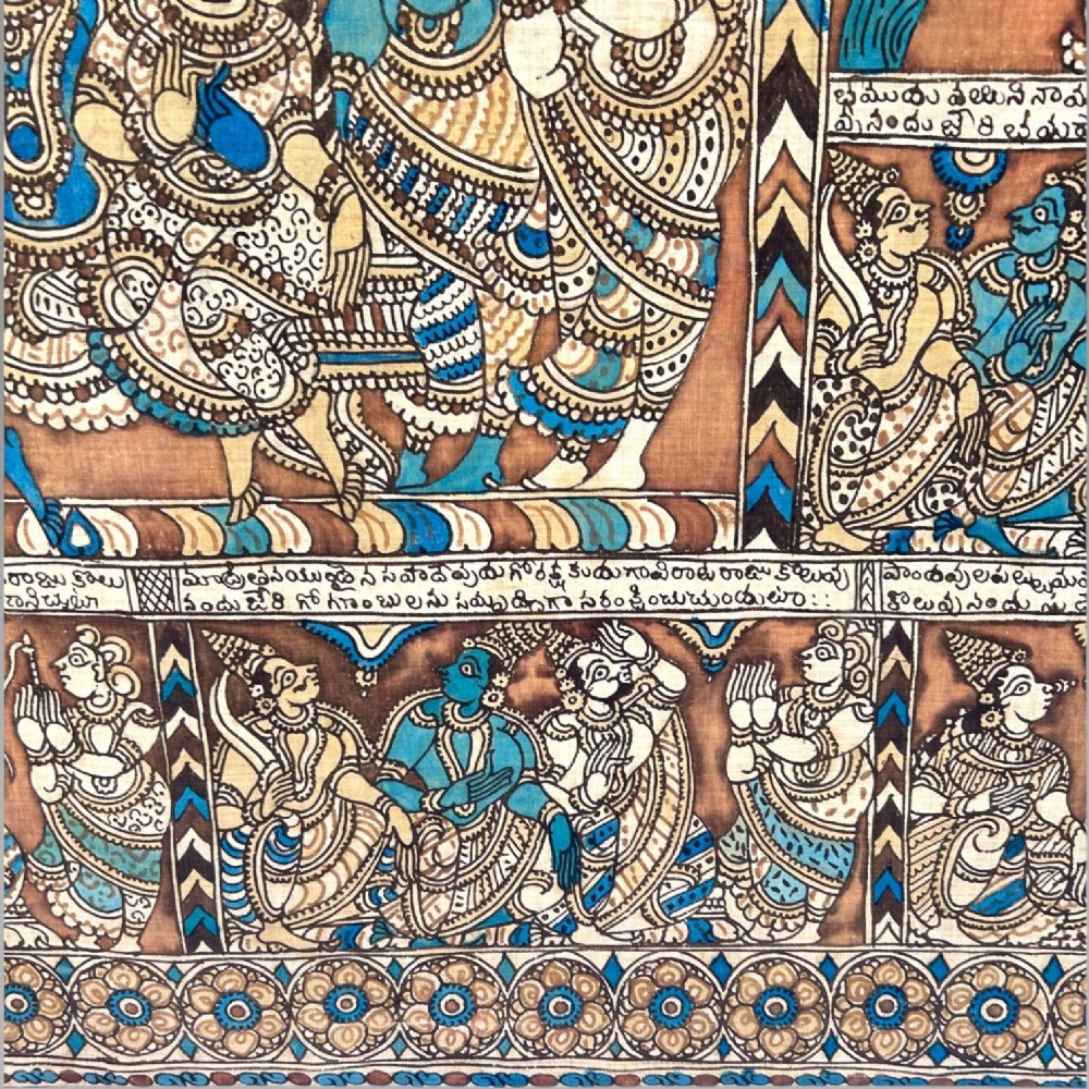 A rectangular Indian Kalamkari cotton textile displaying narrative panels filled with hand-drawn Hindu deities framed by a decorative floral border in blue, beige, and terracotta tones. View XI