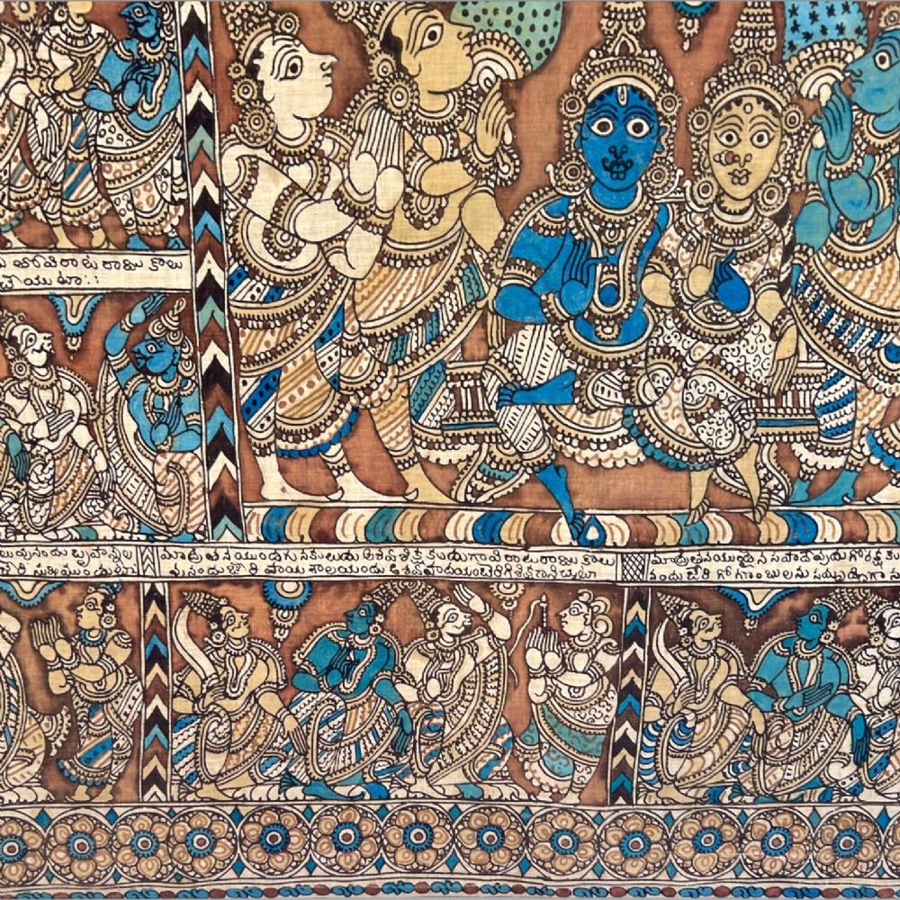A rectangular Indian Kalamkari cotton textile displaying narrative panels filled with hand-drawn Hindu deities framed by a decorative floral border in blue, beige, and terracotta tones. View XII