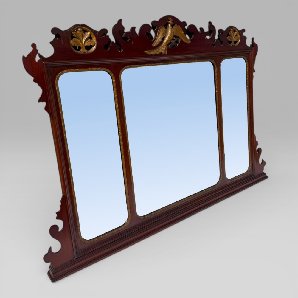 A 19th-century Chippendale style mahogany wall mirror featuring three glass panels, gilt trim, carved shell medallions, and a central gilded bird cresting. View II