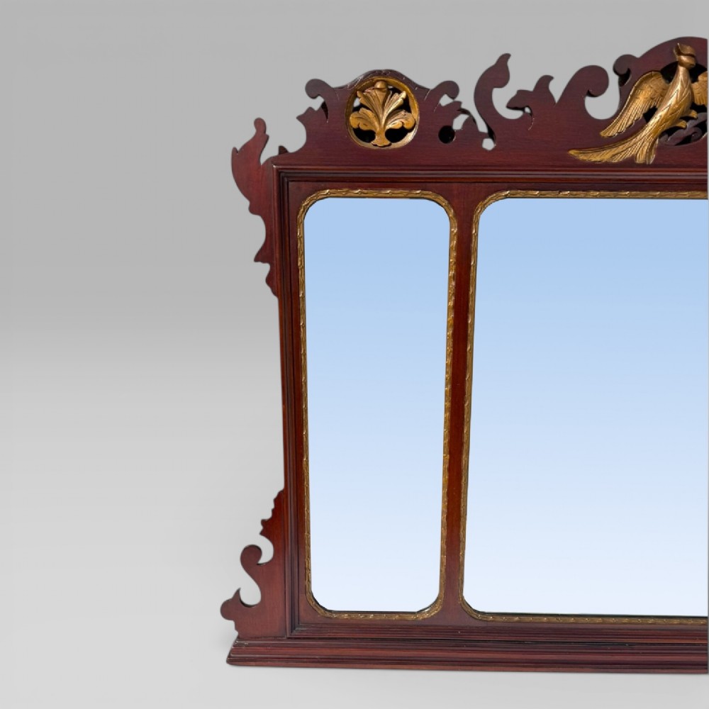 A 19th-century Chippendale style mahogany wall mirror featuring three glass panels, gilt trim, carved shell medallions, and a central gilded bird cresting. View IV