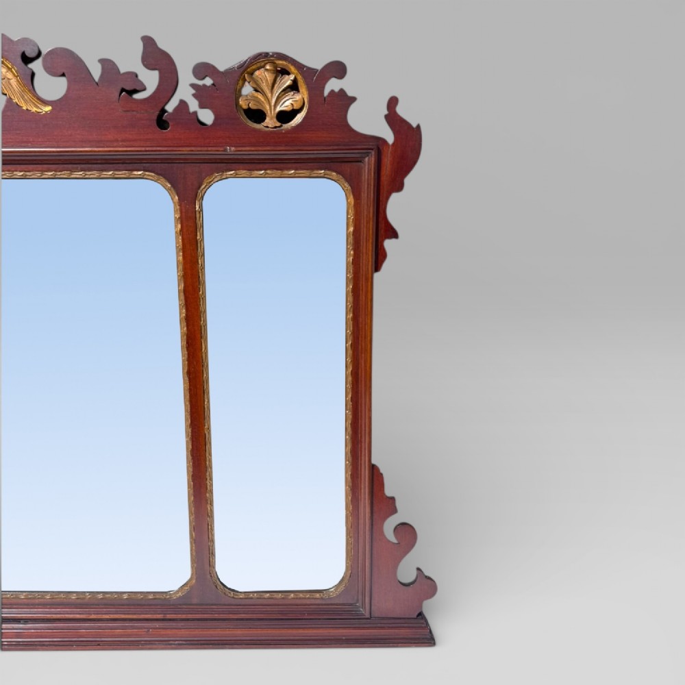 A 19th-century Chippendale style mahogany wall mirror featuring three glass panels, gilt trim, carved shell medallions, and a central gilded bird cresting. View VI