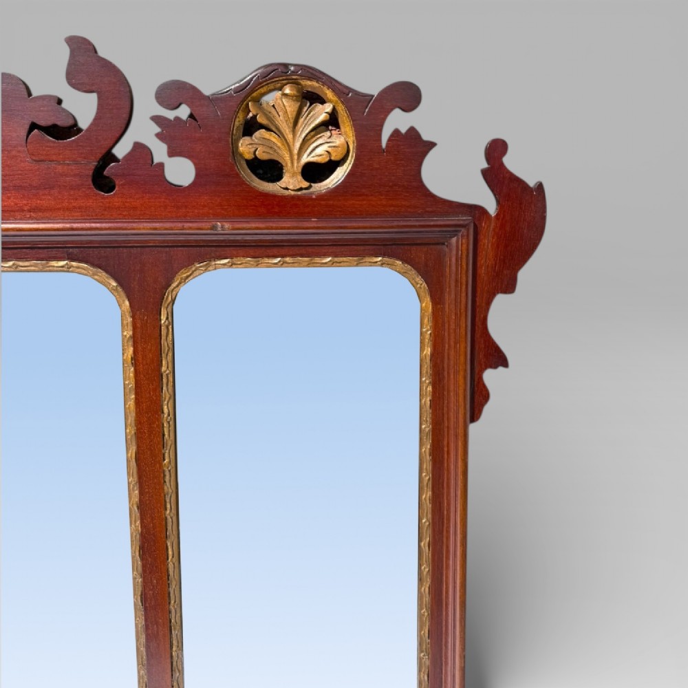 A 19th-century Chippendale style mahogany wall mirror featuring three glass panels, gilt trim, carved shell medallions, and a central gilded bird cresting. View VII