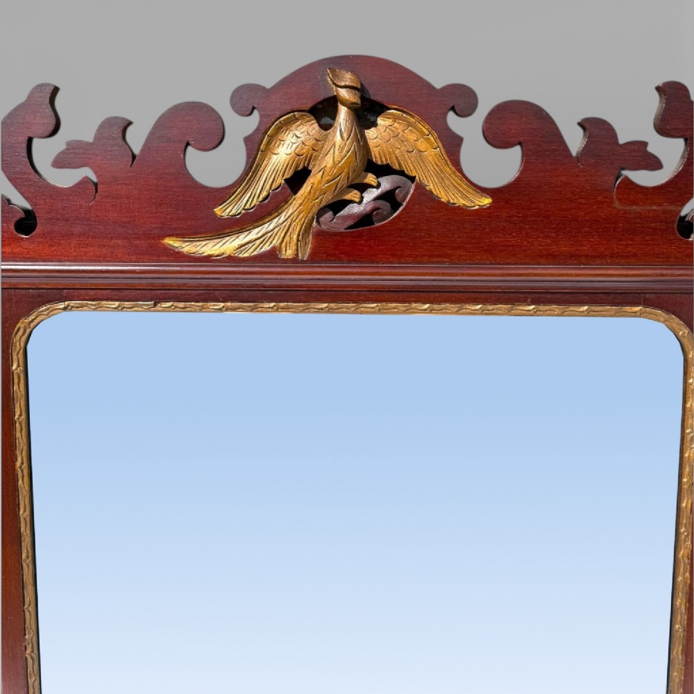 A 19th-century Chippendale style mahogany wall mirror featuring three glass panels, gilt trim, carved shell medallions, and a central gilded bird cresting. View VIII