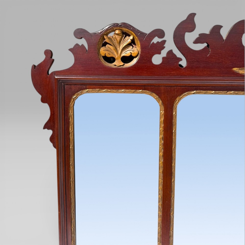 A 19th-century Chippendale style mahogany wall mirror featuring three glass panels, gilt trim, carved shell medallions, and a central gilded bird cresting. View IX