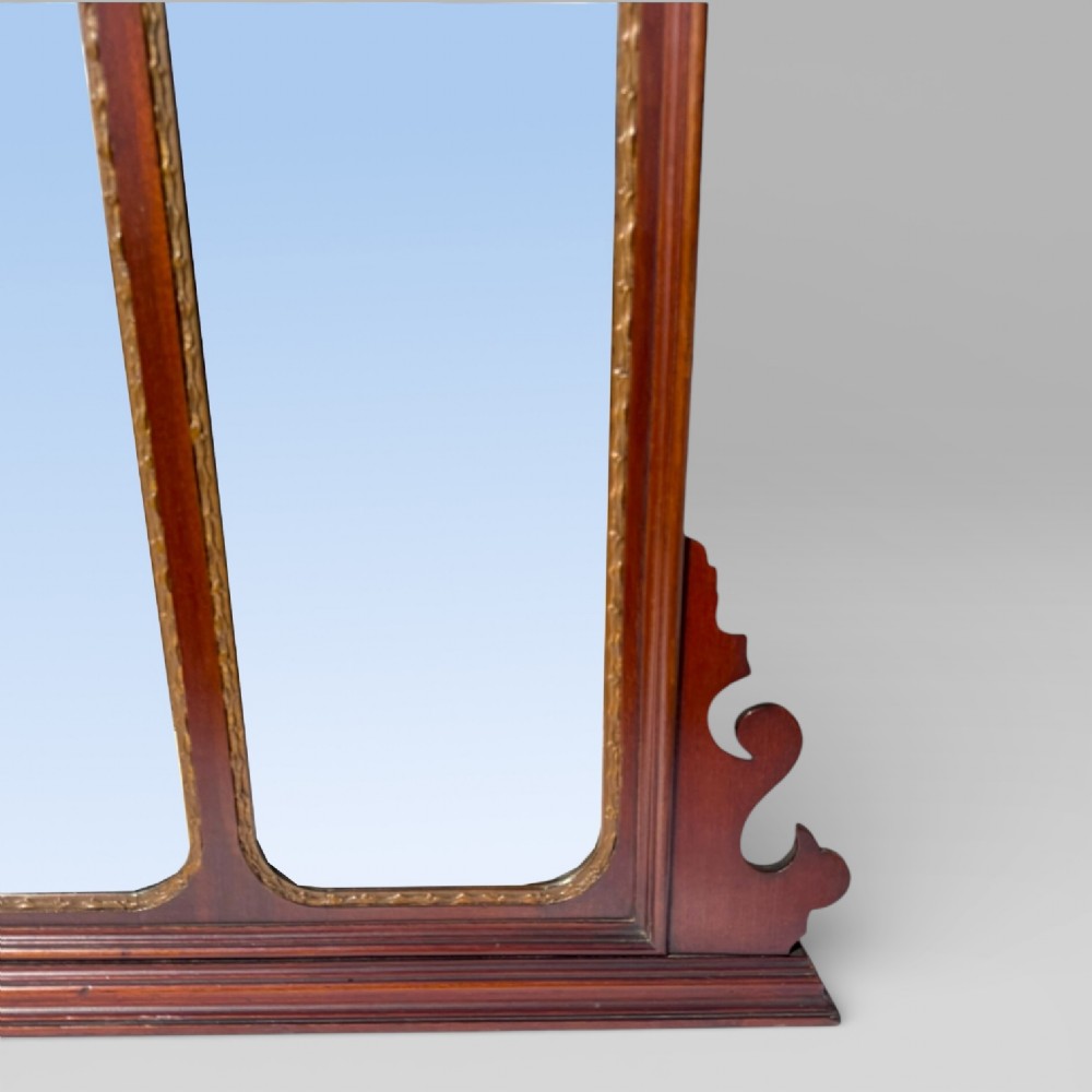 A 19th-century Chippendale style mahogany wall mirror featuring three glass panels, gilt trim, carved shell medallions, and a central gilded bird cresting. View X