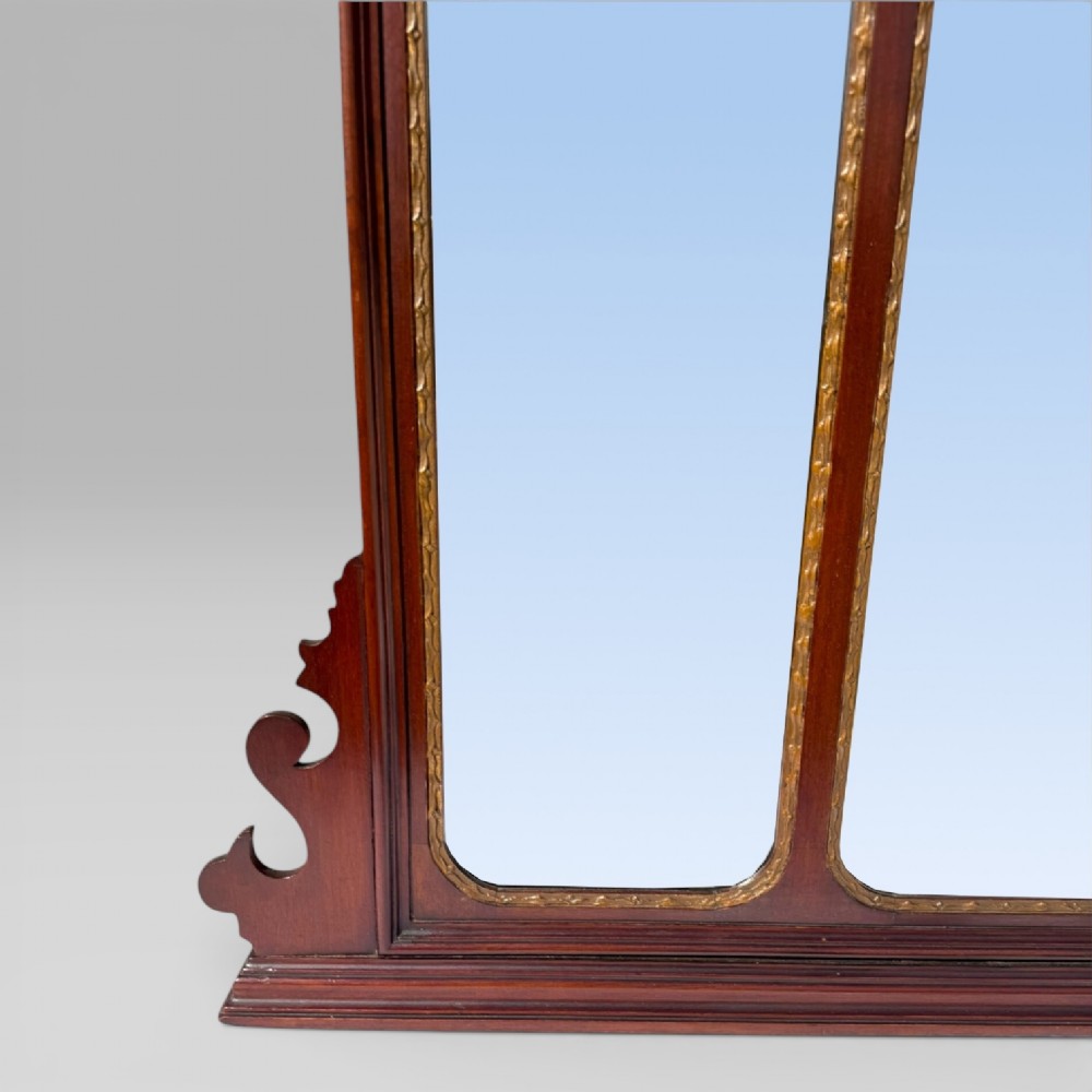 A 19th-century Chippendale style mahogany wall mirror featuring three glass panels, gilt trim, carved shell medallions, and a central gilded bird cresting. View XI