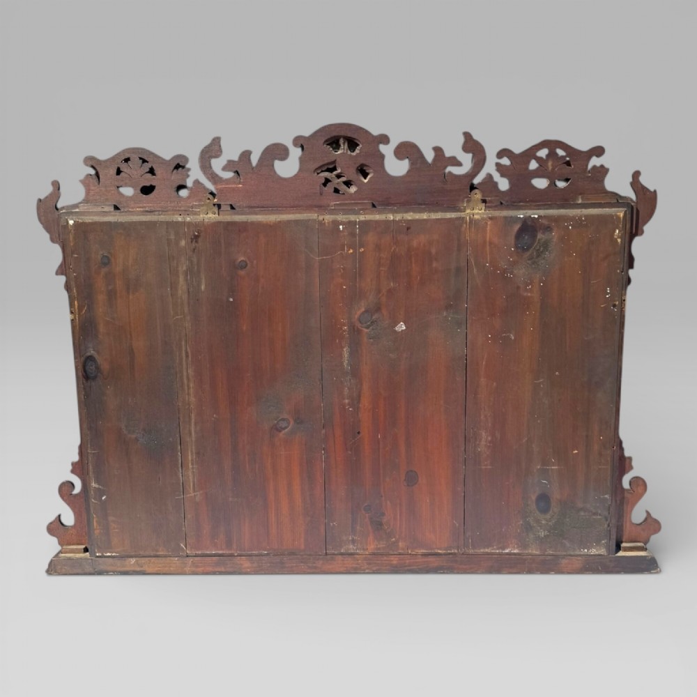 A 19th-century Chippendale style mahogany wall mirror featuring three glass panels, gilt trim, carved shell medallions, and a central gilded bird cresting. View XII