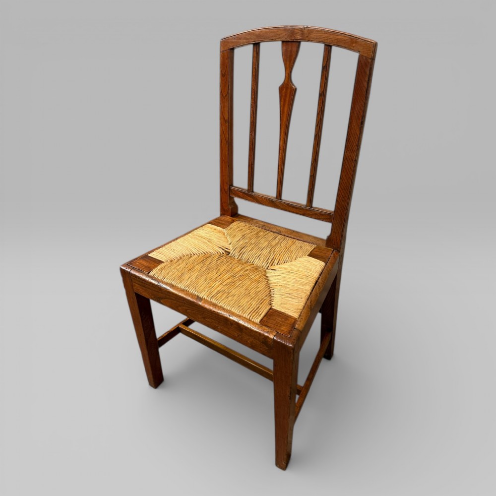 A 19th-century elm side chair featuring a woven rush seat, vertical back slats, and straight legs connected by stretchers. View III