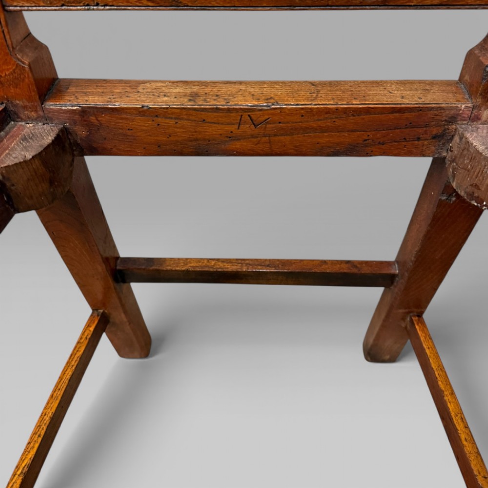 A 19th-century elm side chair featuring a woven rush seat, vertical back slats, and straight legs connected by stretchers. View IX