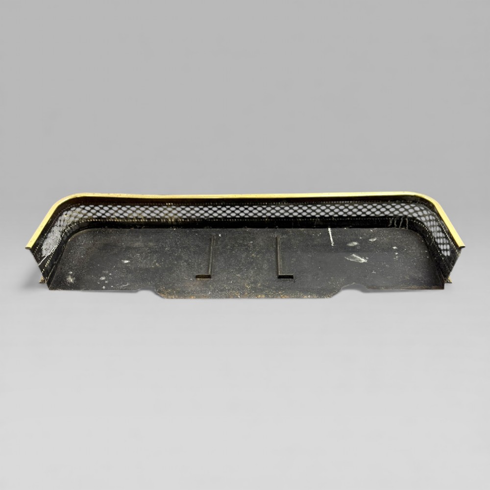 A long Victorian brass fire fender featuring a pierced lattice pattern, beaded edge trim, and low support feet. View V