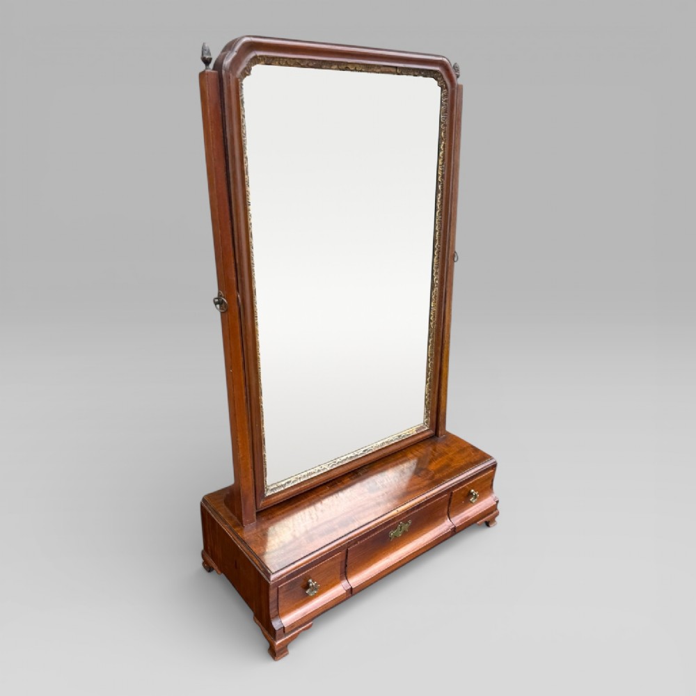 An 18th-century Georgian mahogany dressing table mirror featuring an arched glass frame with a gilt inner slip, brass finials, and a plinth base fitted with drawers. View III
