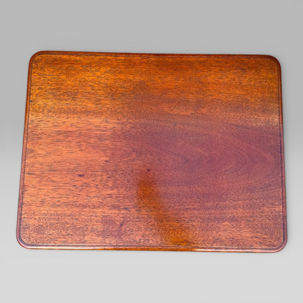 A Victorian mahogany centre table featuring a rectangular top with moulded edge, two frieze drawers with brass drop handles, carved shaped end supports, and a turned stretcher. View VII