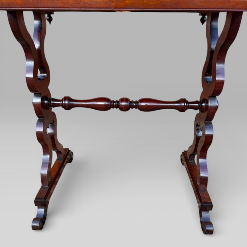A Victorian mahogany centre table featuring a rectangular top with moulded edge, two frieze drawers with brass drop handles, carved shaped end supports, and a turned stretcher. View X
