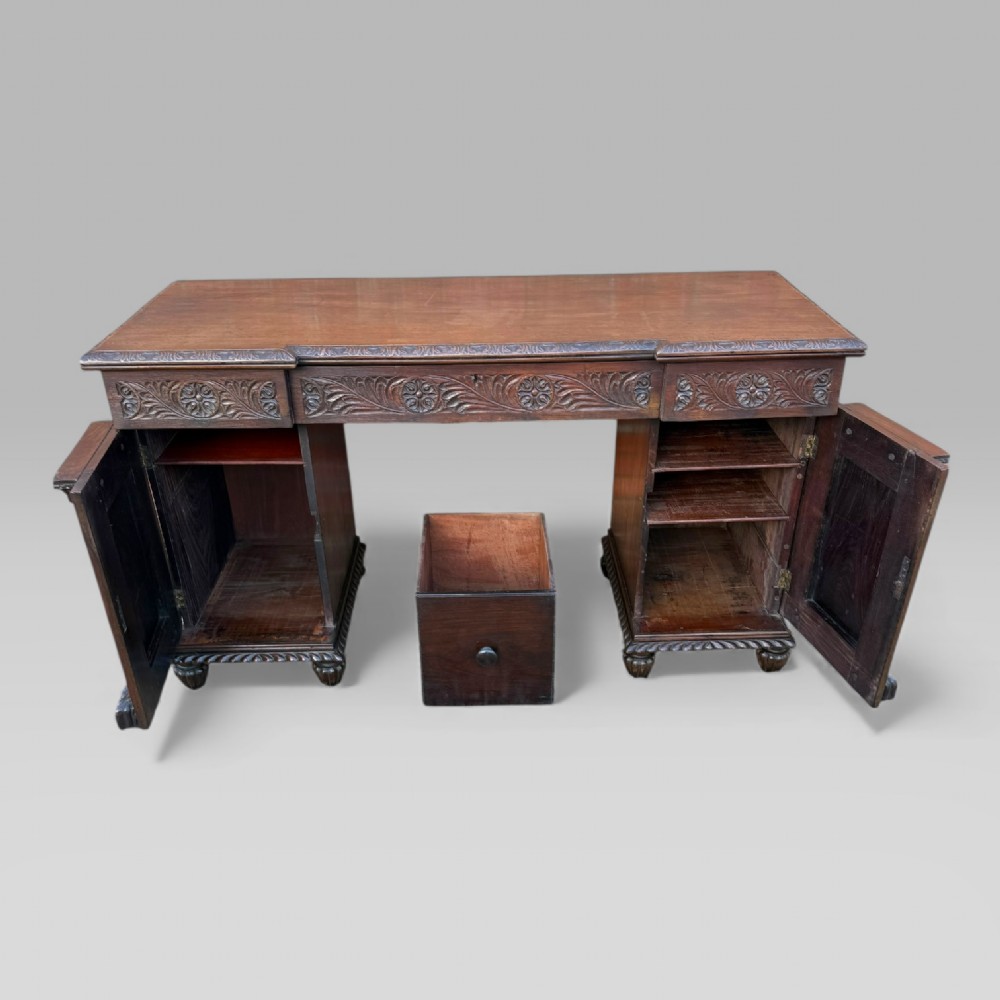 A dark carved padouk wood sideboard featuring intricate floral frieze carvings, sunburst panel pedestals, and a central kneehole design. View VIII