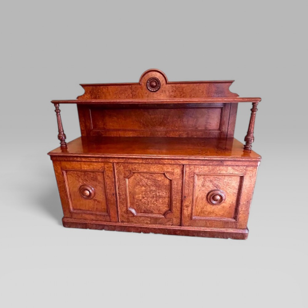 Victorian pollard oak three door buffet sideboard featuring a raised upper shelf supported by turned pillars and panelled cupboard doors with carved circular bosses.