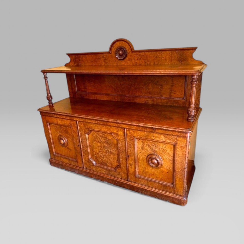 Victorian pollard oak three door buffet sideboard featuring a raised upper shelf supported by turned pillars and panelled cupboard doors with carved circular bosses. View II