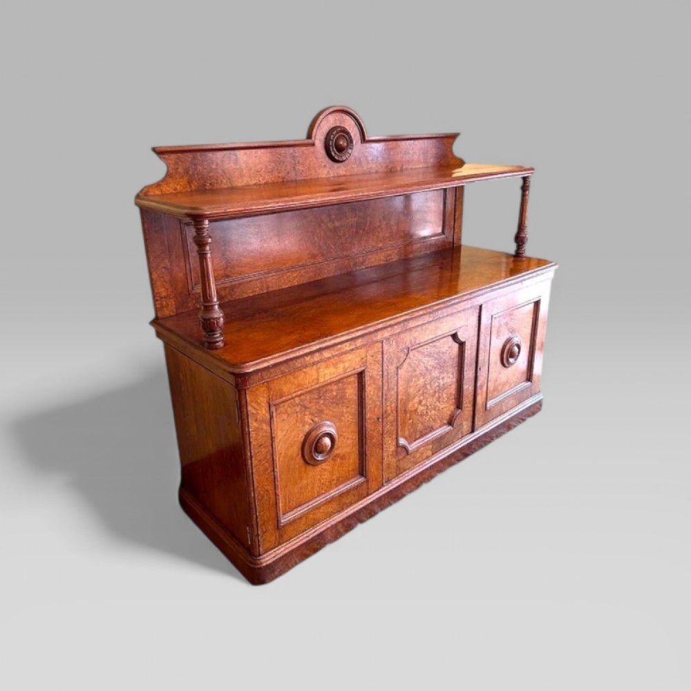 Victorian pollard oak three door buffet sideboard featuring a raised upper shelf supported by turned pillars and panelled cupboard doors with carved circular bosses. View III