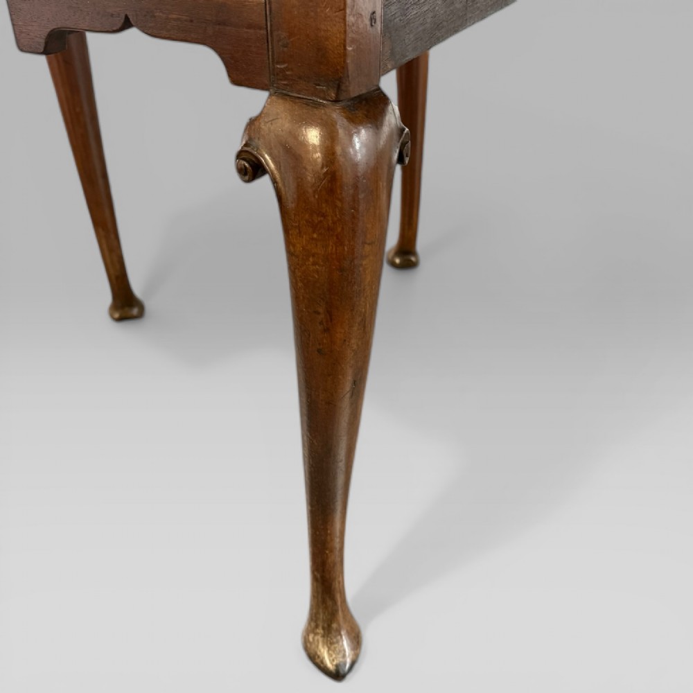 An 18th-century George II mahogany drop-leaf table with hinged oval flaps, cabriole legs terminating in pad feet, and a side drawer with a brass handle. View VIII
