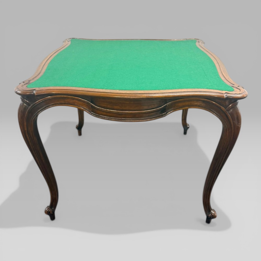 An antique French walnut card table featuring a green baize top, serpentine edges, four drawers, and carved cabriole legs. View II