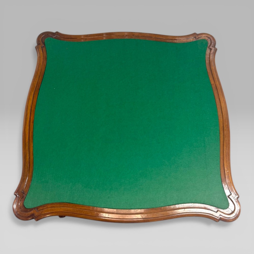 An antique French walnut card table featuring a green baize top, serpentine edges, four drawers, and carved cabriole legs. View III