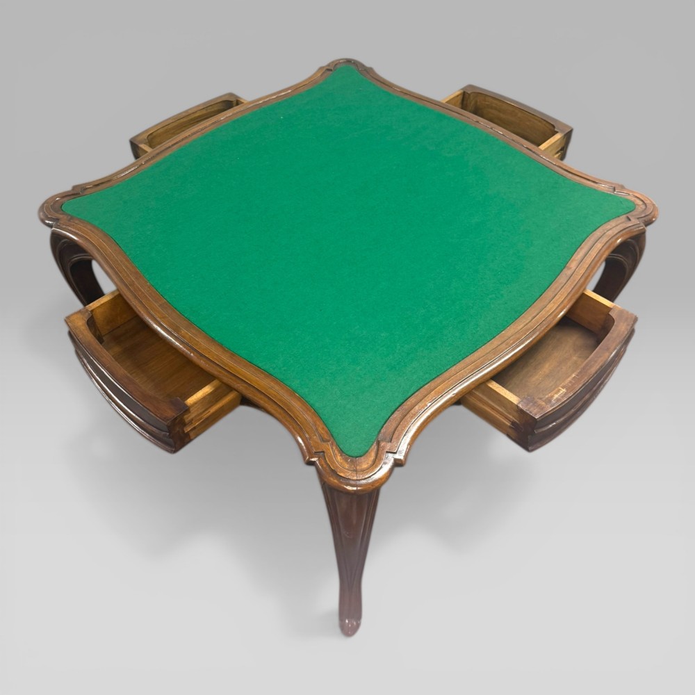 An antique French walnut card table featuring a green baize top, serpentine edges, four drawers, and carved cabriole legs. View IV