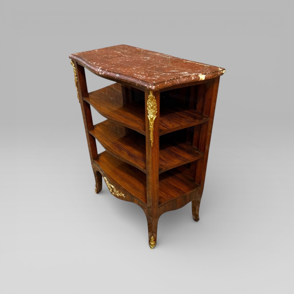 A French Louis XV style rosewood open side cabinet featuring a red marble top, three tiered shelves, and decorative brass ormolu mounts. View II